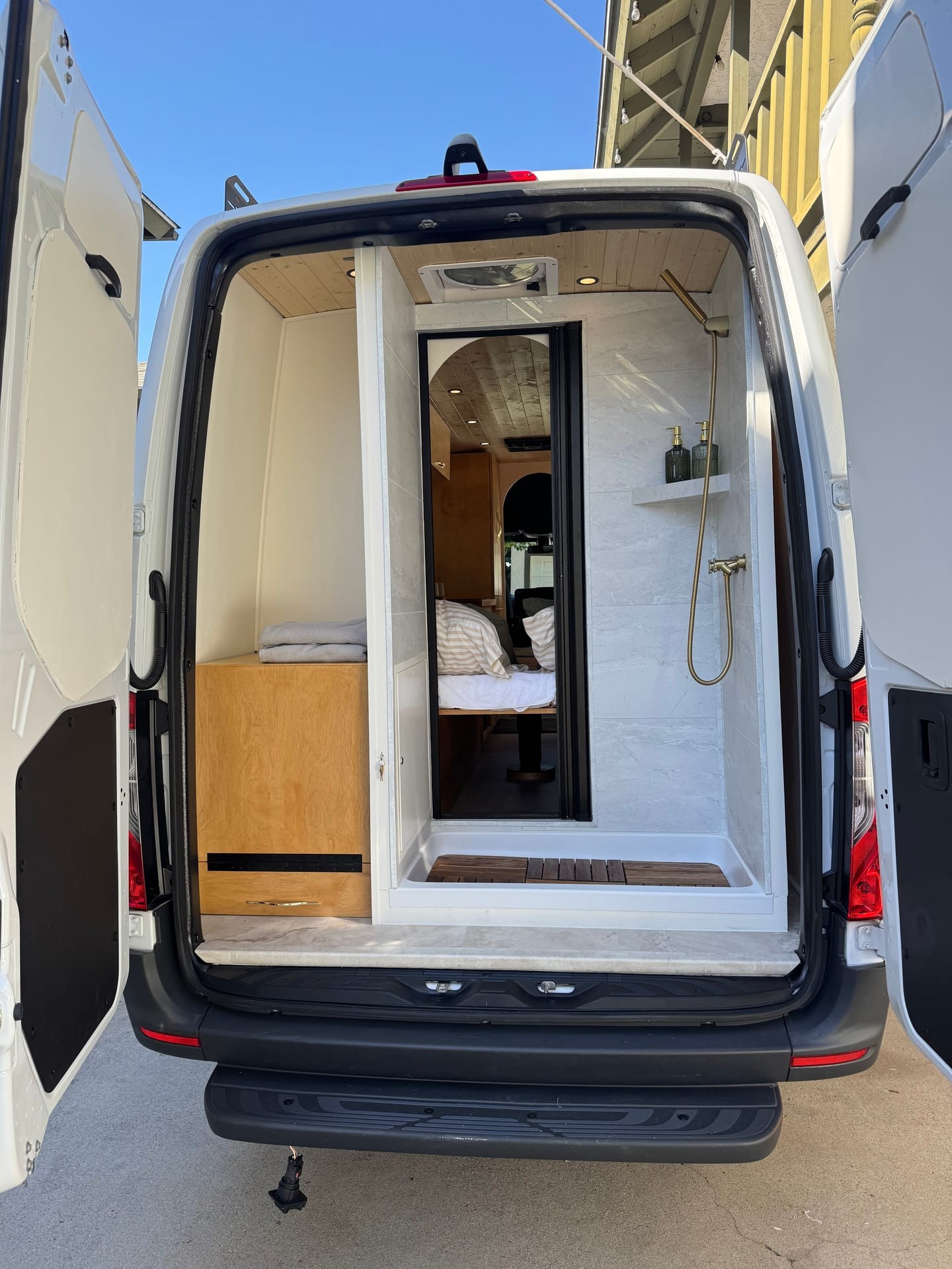 Anchor Sprinter van rear view with marble shower and bed