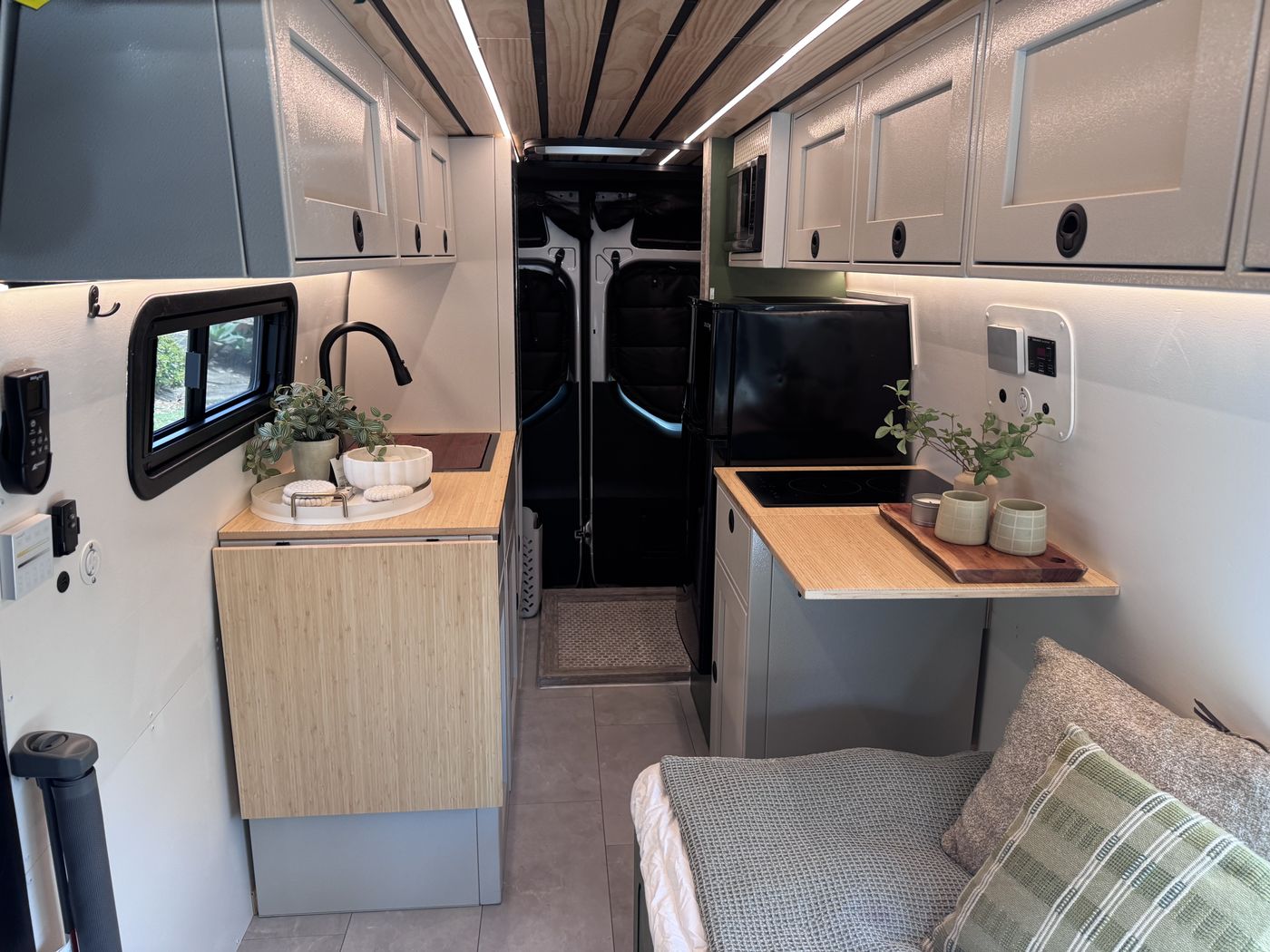 Grove Sprinter 170 Extended interior looking from the cab toward the rear, galley on both sides and bench bed at right