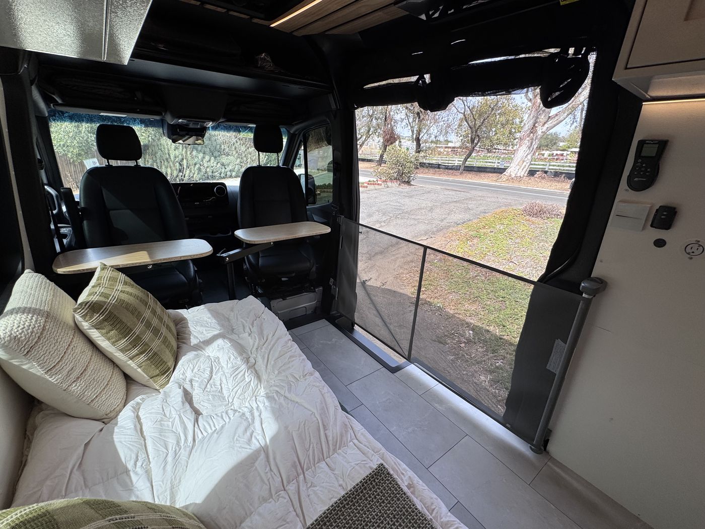 Grove Sprinter with both swivel tables deployed at the cab seats and the retractable dog gate across the sliding door