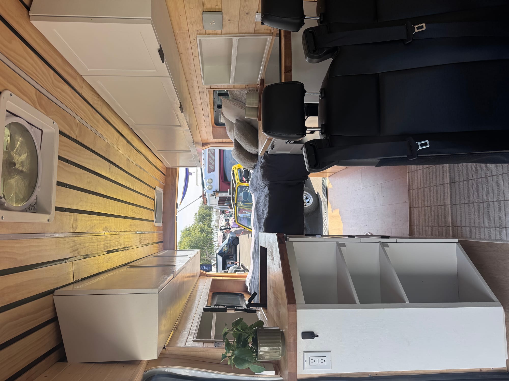 Finished Ford Transit van conversion interior showing kitchen, cabinetry, and living space by Emery Custom Builds