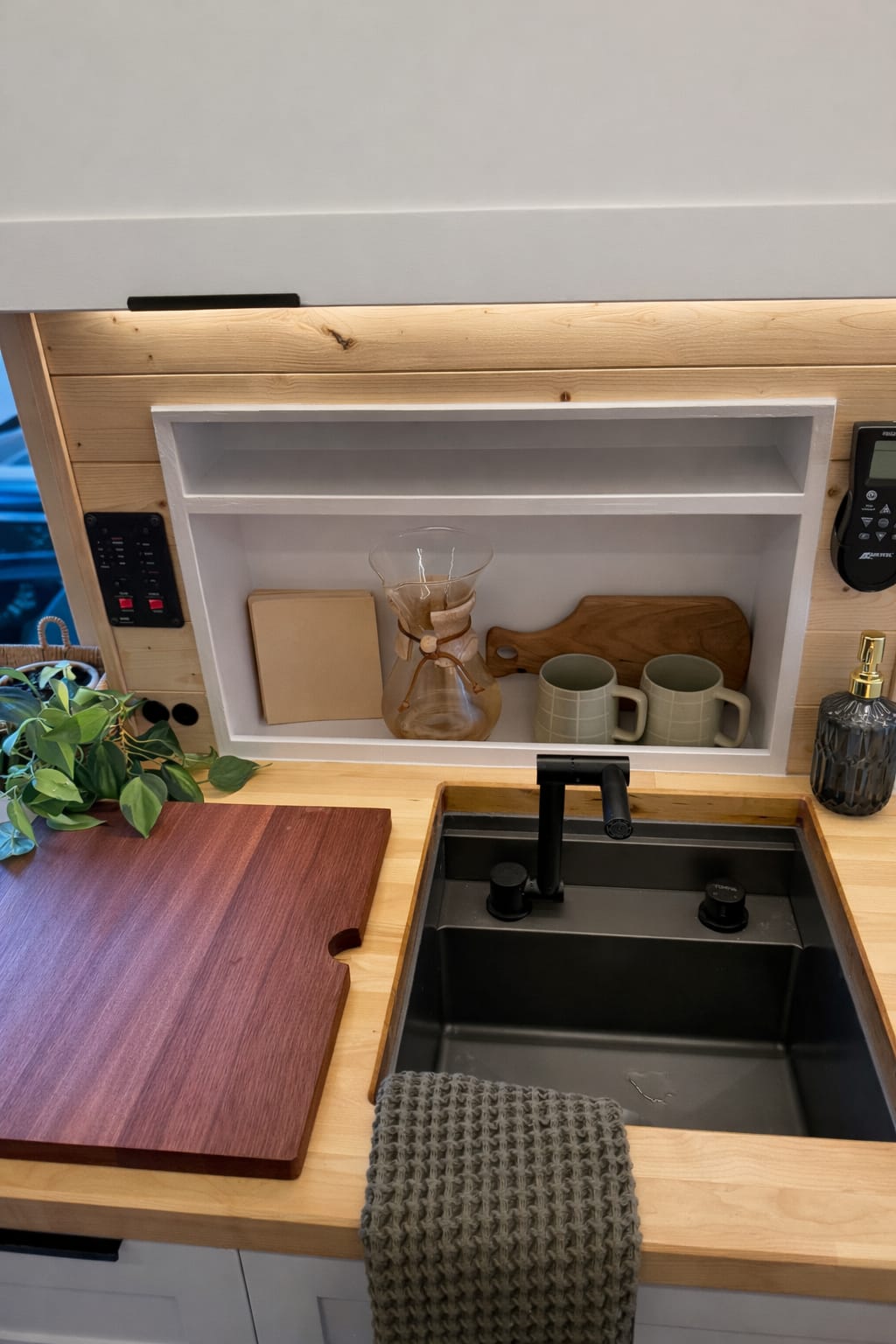 Custom van conversion interior with kitchen setup ready for van life in San Diego